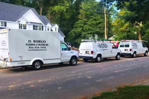 D. Burgo plumbing and heating vans parked outside of a customer